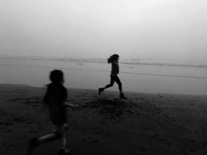 Ryan and her younger brother River running around on the beach.