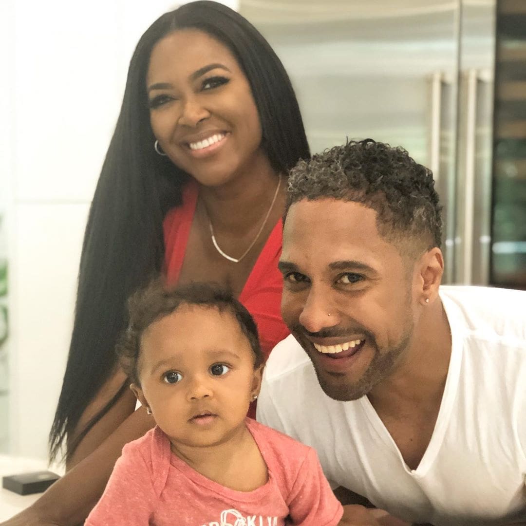 Marc Daly and Kenya Moore smiling with their daughter Brooklyn Doris Daly.
