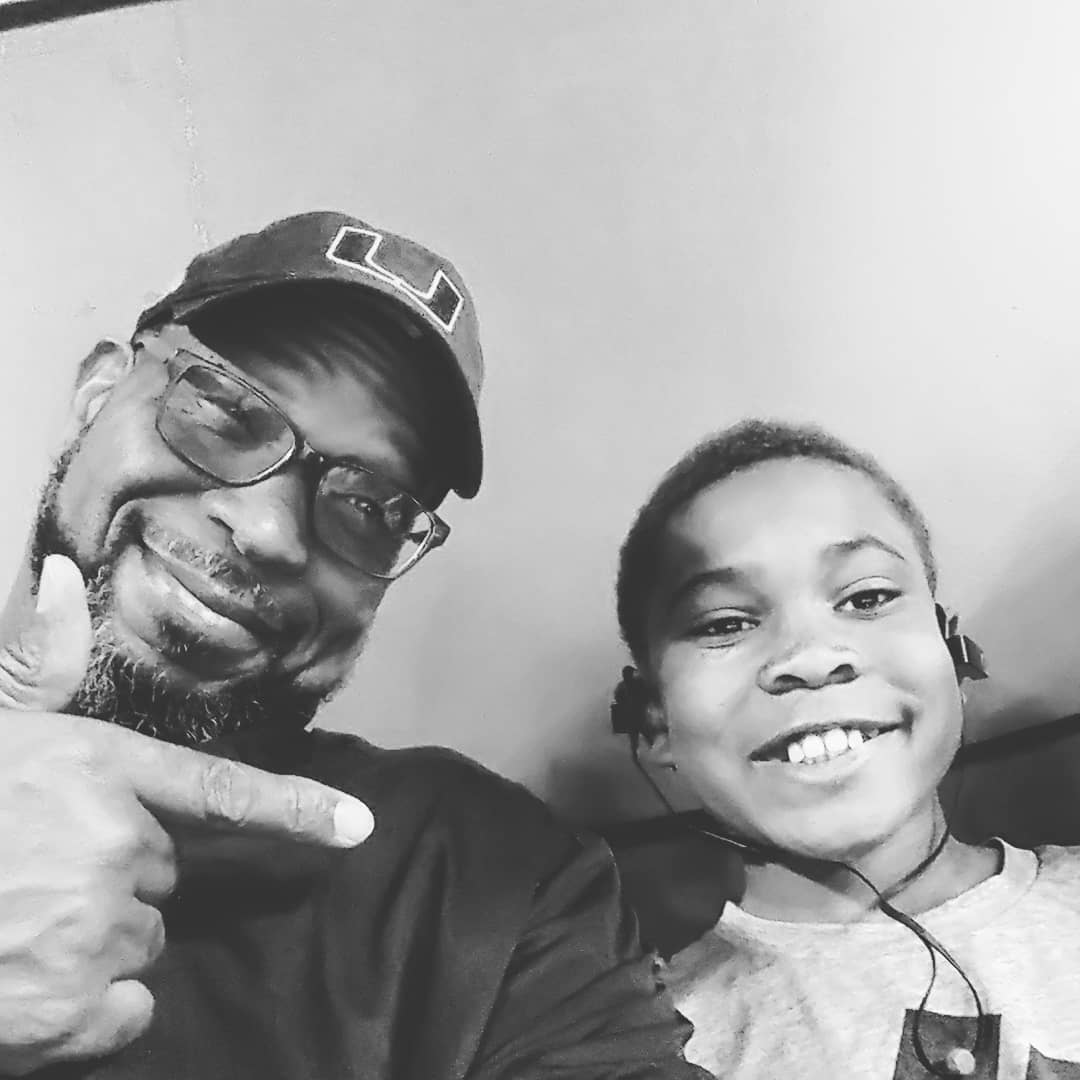 A black and white picture of Luther Campbell with his son Blake Campbell.