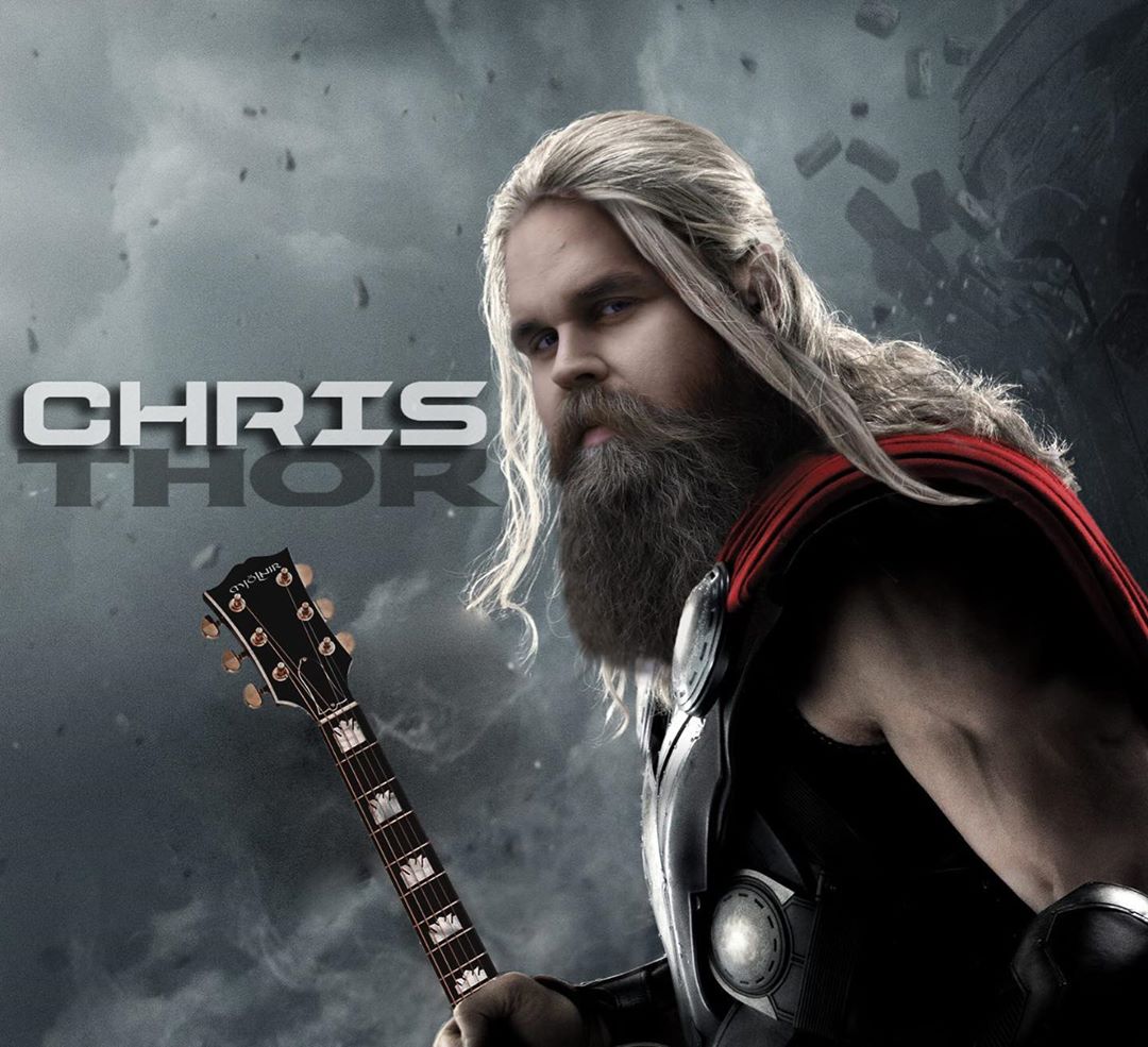 Edited picture of Chris Klafford in Thor's dress holding guitar.