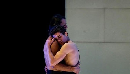 A picture of Jaime Lorente hugging his other cast from the theater act The House of Bernarda Alba.