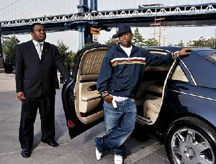 Damon Dash posing in one of his cars.