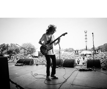 Finn Wolfhard playing guitar while on concert with his old band Calpurnia.