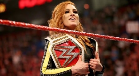 Becky Lynch holding her WWE's championship belts.