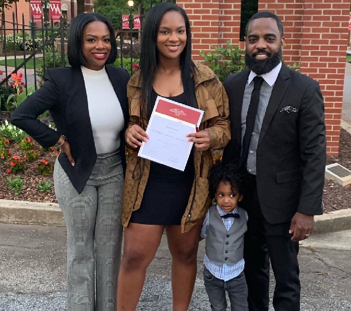 Riley Burruss with her family in school program.