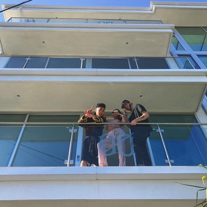 RiceGum posing out of his balcony with his friends.