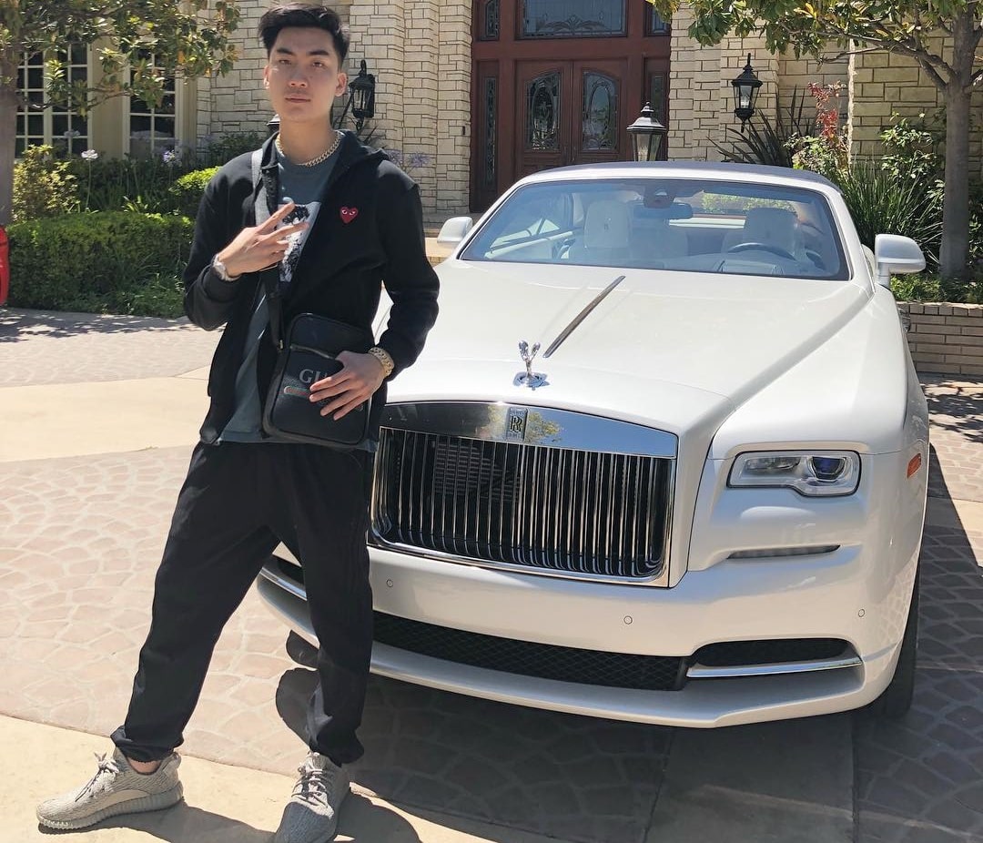 RiceGum poses with his White Rolls Royce.