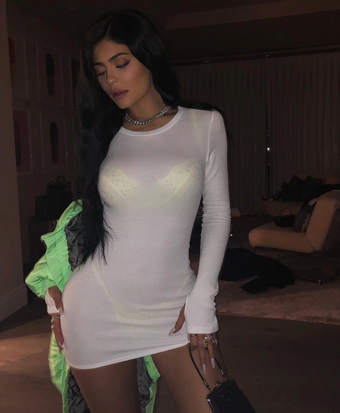 Kylie in a see through white dress revealing the neon bra and brief set.