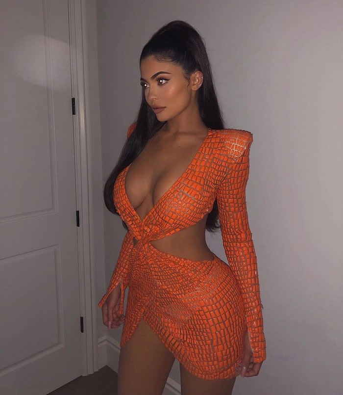Kylie in an orange Julian MacDonald dress.
