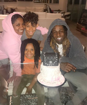 Neal Carter taking a family photo along with his father Lil Wayne, sister Reginae Carter and brother Dwayne Carter III.