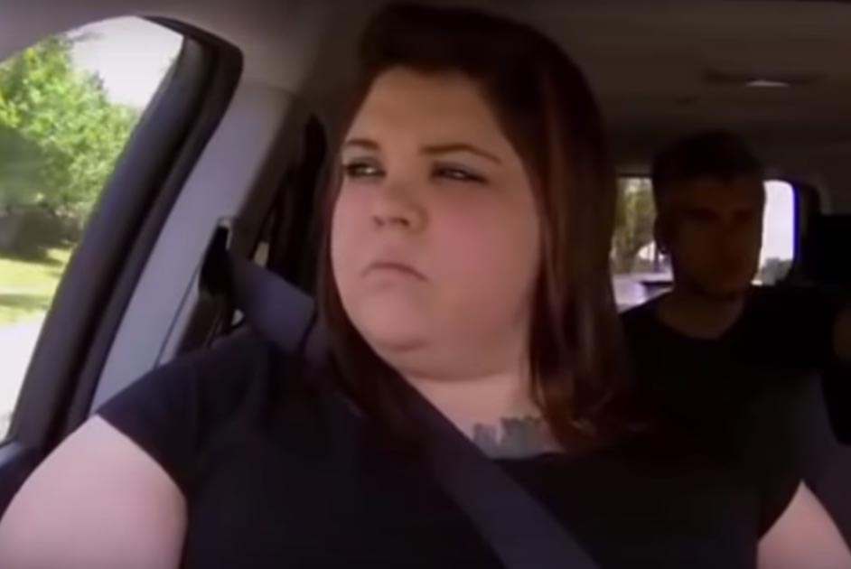 Ashley riding in a car with catfish team.