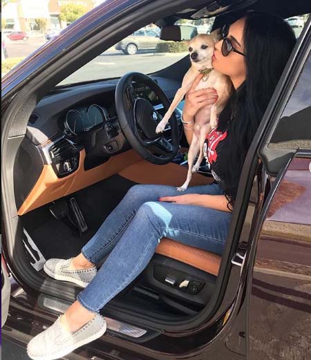 Paris Roxxane take a picture with her dog in a car. 