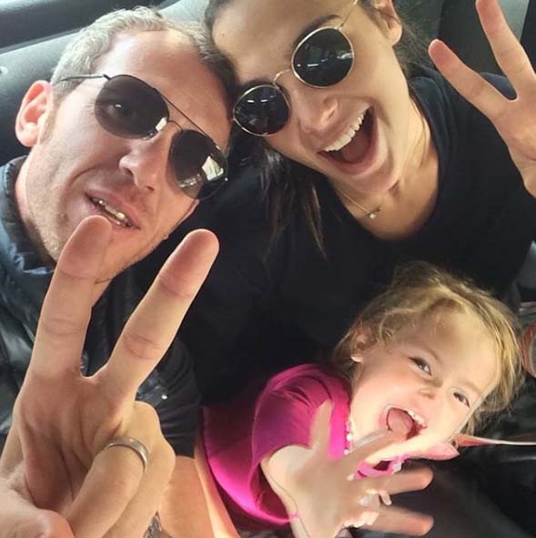 Yaron Varson taking a picture with his wife 'Gal' and daughter 'Alma'.
