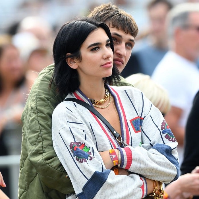 Anwar Hadid with Dua Lipa on his arms.