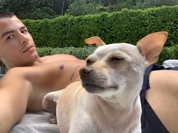 Monolo sunbathing with his dog Baguette Gonzalez.