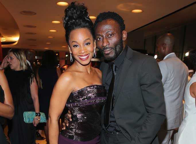 Anika Noni Rose and Babs Olusanmokun taking a picture together.