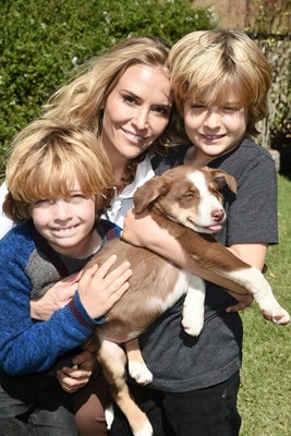 Bob with his twin brother and a mother holding an adorable furry friend.