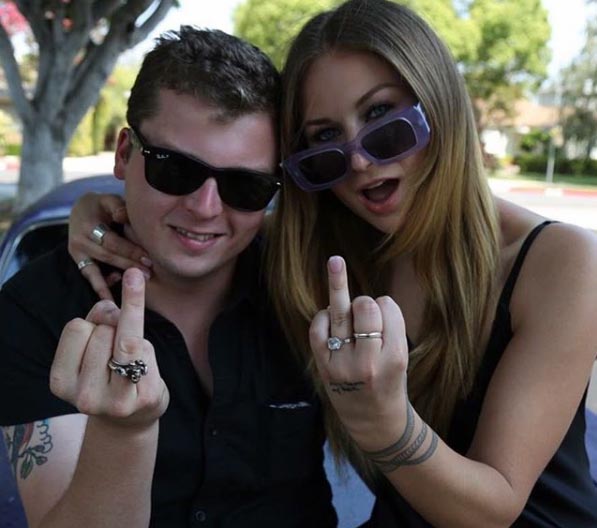 Spencer Breslin and Grace Tame showing their rings.