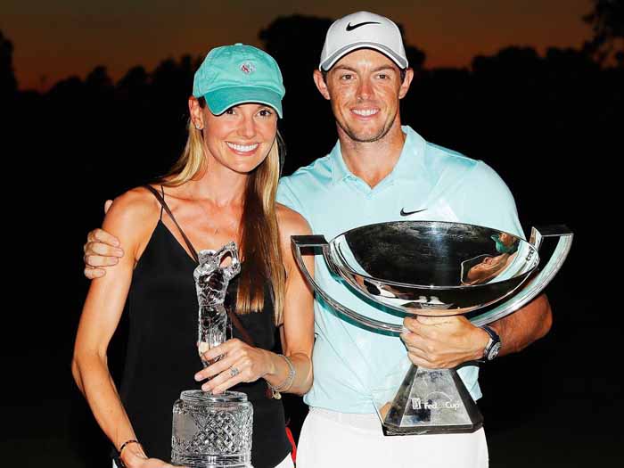 Erica Stoll and her husband Rory Mcllroy poses with a trophies.