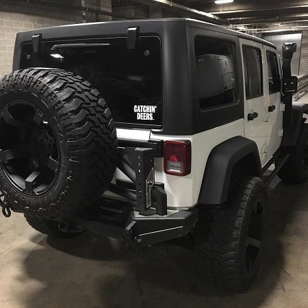 A picture of black and white Jeep owned by Mike Fisher.