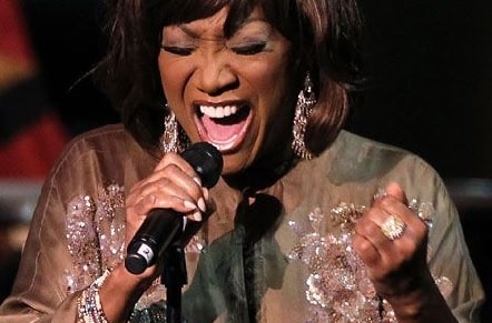 A picture of Patti Labelle singing.