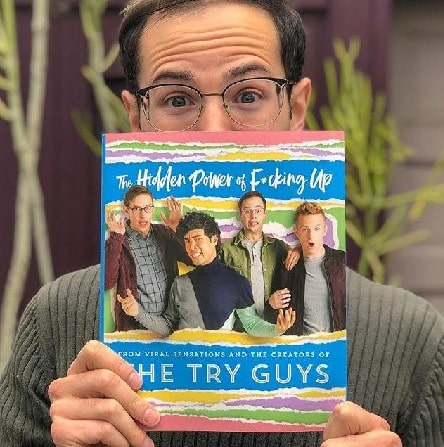 Zach Kornfeld holding his book named 'The Hidden Power of F*cking Up'. 