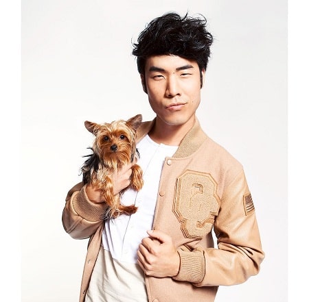 Eugene Lee Yang with the dog which he found in the lobby during his photo shoot.