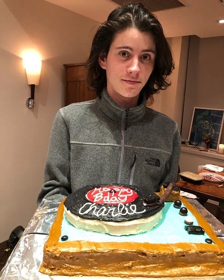 A picture of  Charles Ezekiel Mozes holding the cake Cynthia Nixon and Christine Marinoni made.