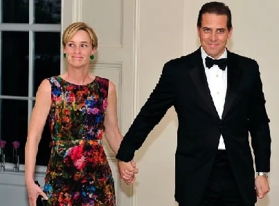 Finnegan Biden parent's Hunter Biden and Kathleen Biden holding hands.