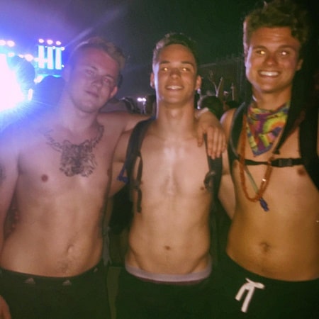 A picture of Somer Hollingsworth with his friends, where you can see his caved chest. 