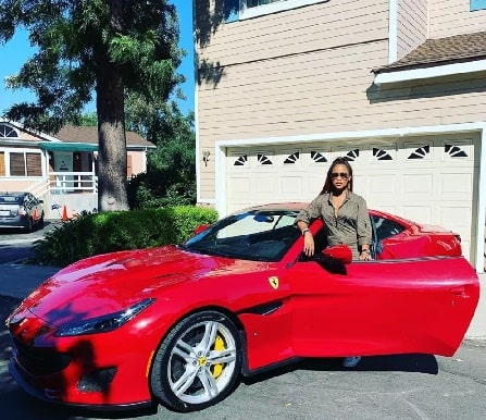 Eve in her red-colored Ferrari