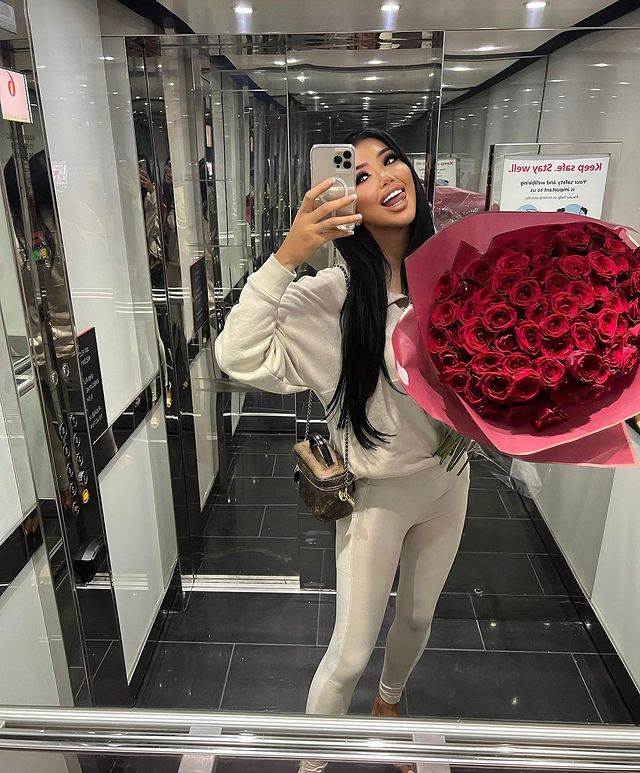 Chloe Khan carrying a flower bouquet
