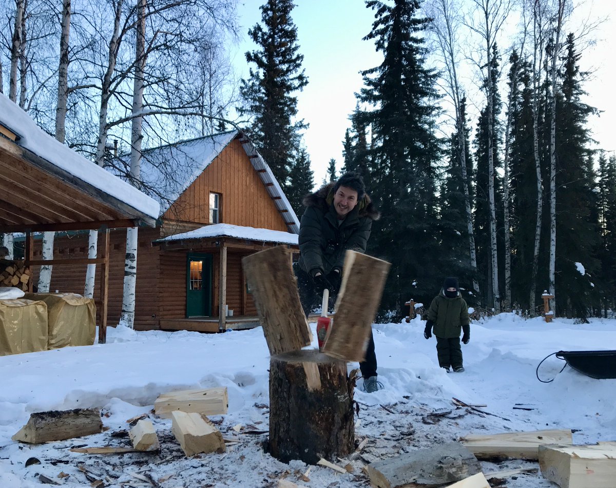 Glenn Villeneuve cutting woods outside of his cabin