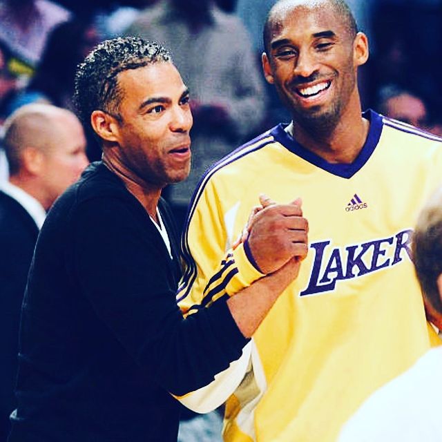 chris ivery wearing a black sweater and kobe wearing a laker white jersey.