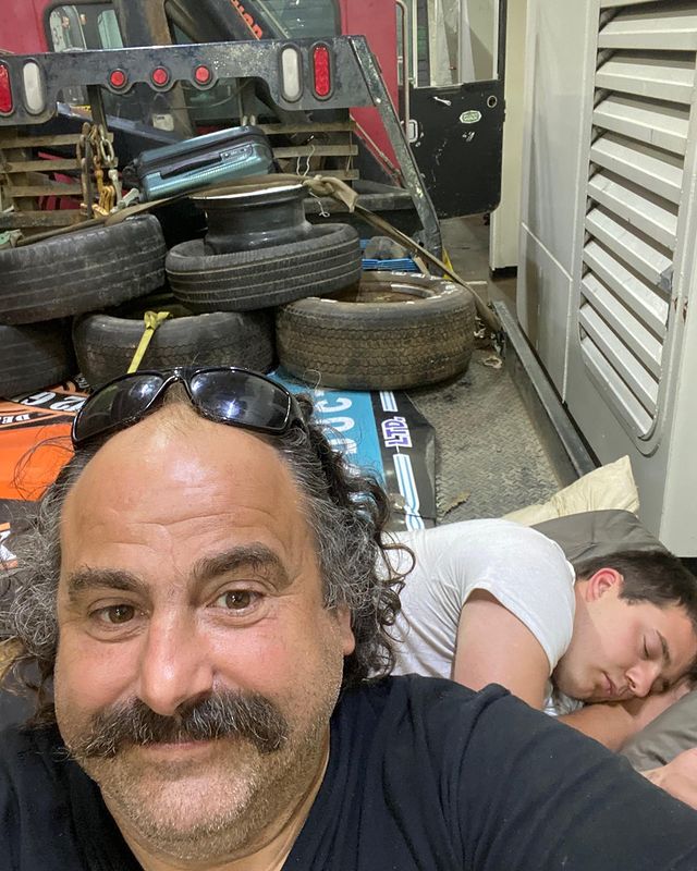 Avery Shoaf with in his garage and his son sleeping in the back