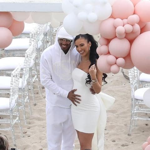 Breana Tiesi with her now boyfriend Nick Cannon celebrating her baby shower wearing a white strap dress
