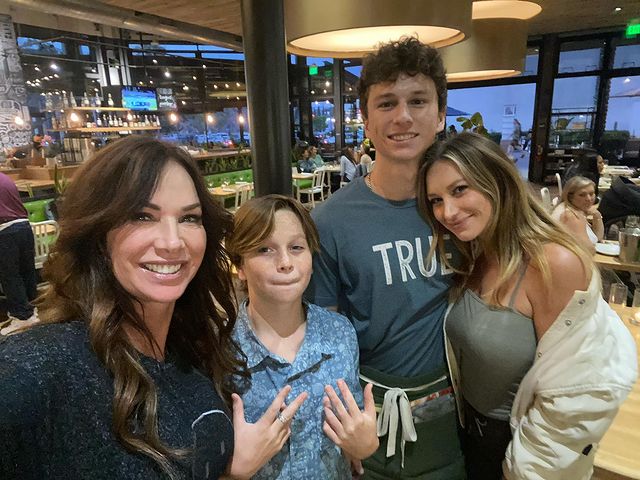 Debbe Dunning with her children outside for a dinner wearing a formal clothes
