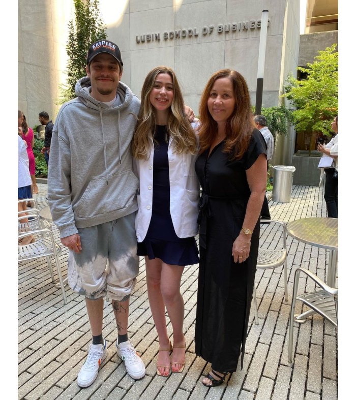 Amy Waters Davidson with her son and daughter on a cafe wearing a long black dress