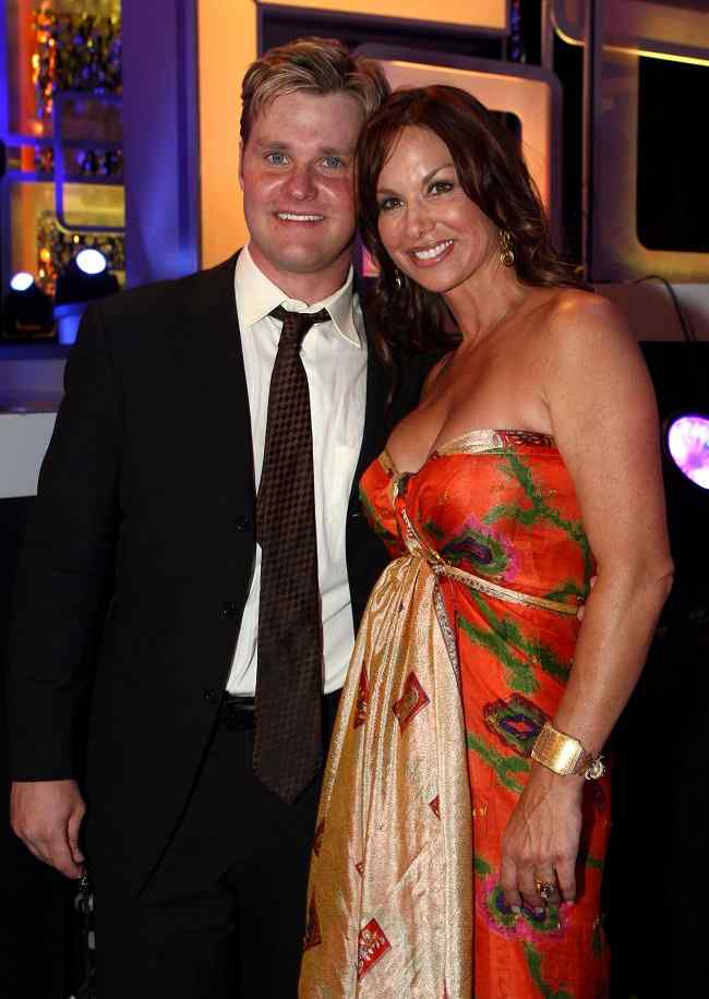 Debbe Dunning with her former husband Steve Timmons wearing a floral strapless dress 