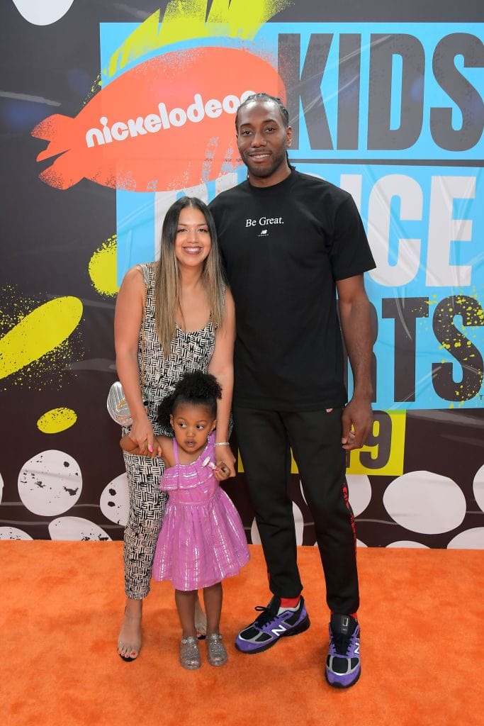 Kishele Shipley with her husband and daughter in a nickelodeon award show wearing a long shimmer dress