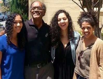 Kishele Shipley with her family during her teenage days wearing a jean jacket and a black gown 