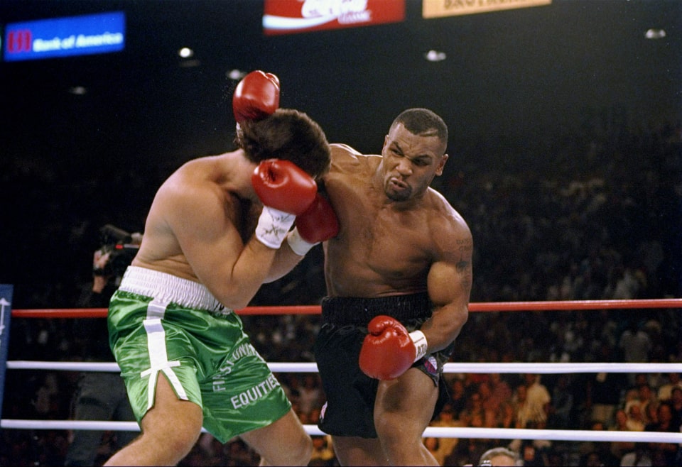 Peter McNeeley boxing the another championship star Mike Tyson wearing a green half pant