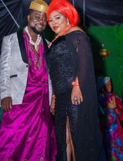 Rita Daniels with her new husband doing their marriage rituals wearing a black cultural dress 