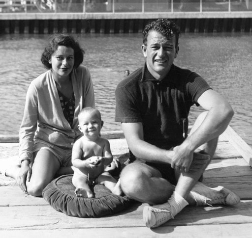 Josephine Wayne with her family sitting in the river side wearing shorts and t-shirt