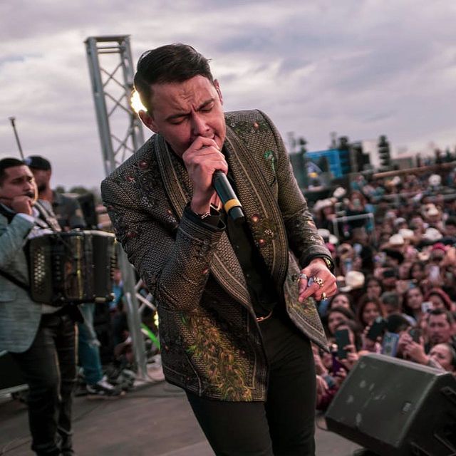 Luis Afonso Partida Cisneros in a musical tour in USA giving his best on the stage wearing a floral printed suit pant