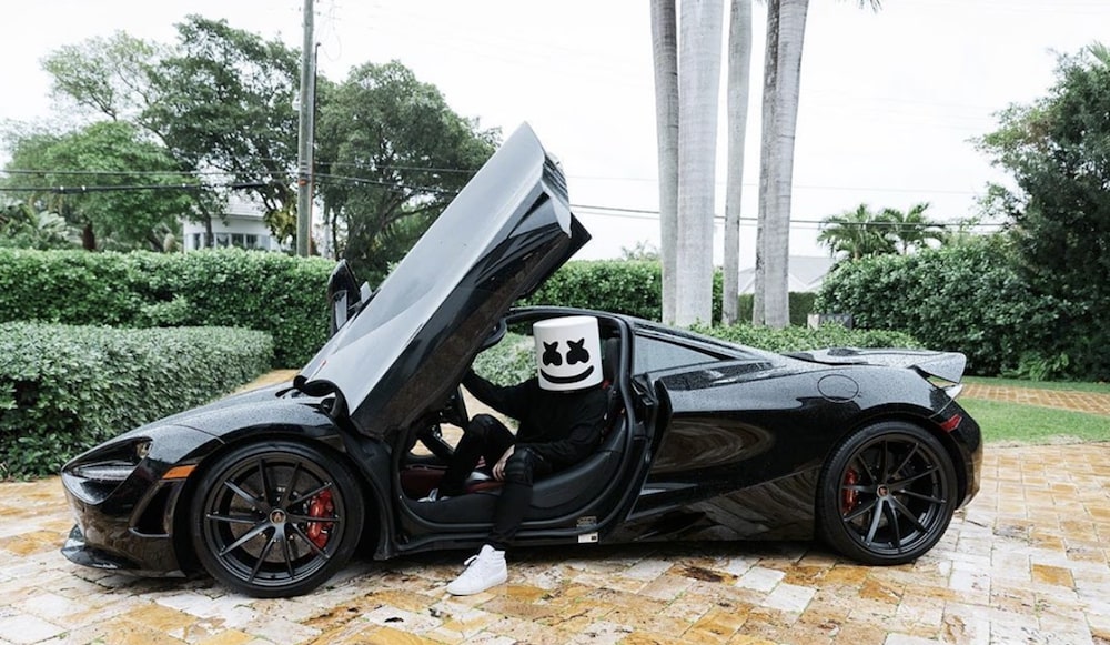 Marshmello doing photoshoot in his expensive McLaren 720S wearing a full black for a black themed photography 