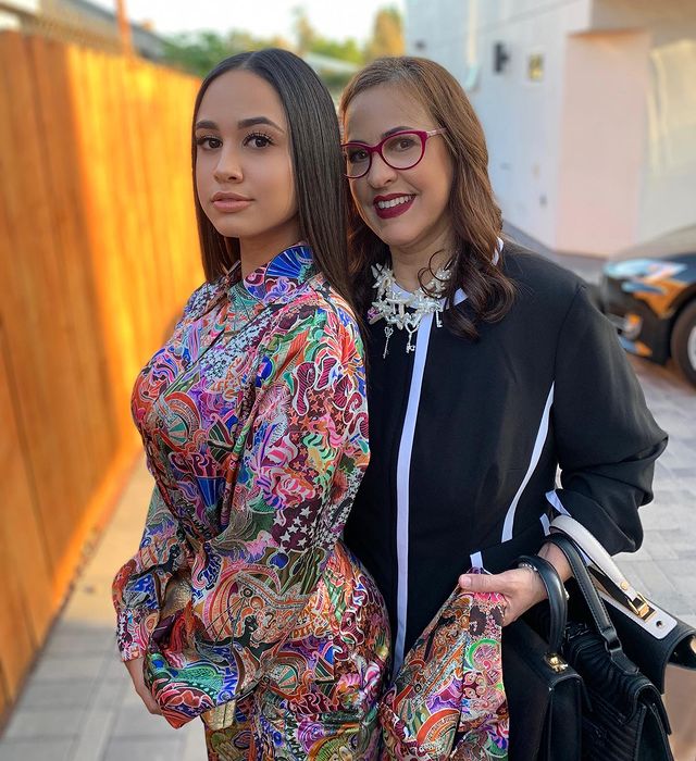 Emily Tosta with her mother wearing a art printed colorful suit 