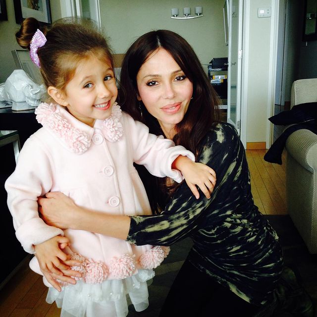 Lucia Gibson with her mother Oksana Grigorieva wearing a baby pink color jacket and a white skirt