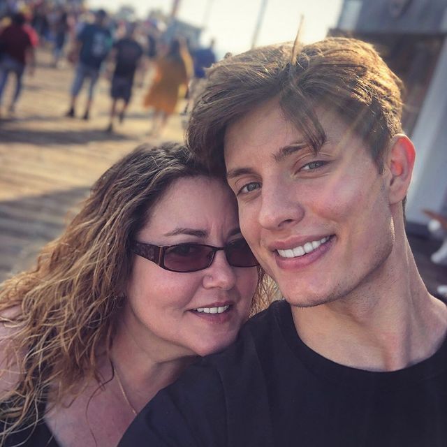 Matt Rife with his mother April on a holiday wearing a formal black t-shirt