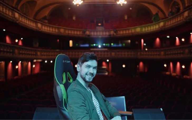 Picture of Jacksepticeye posing for a photo sitting on a gaming chair in a big game event.